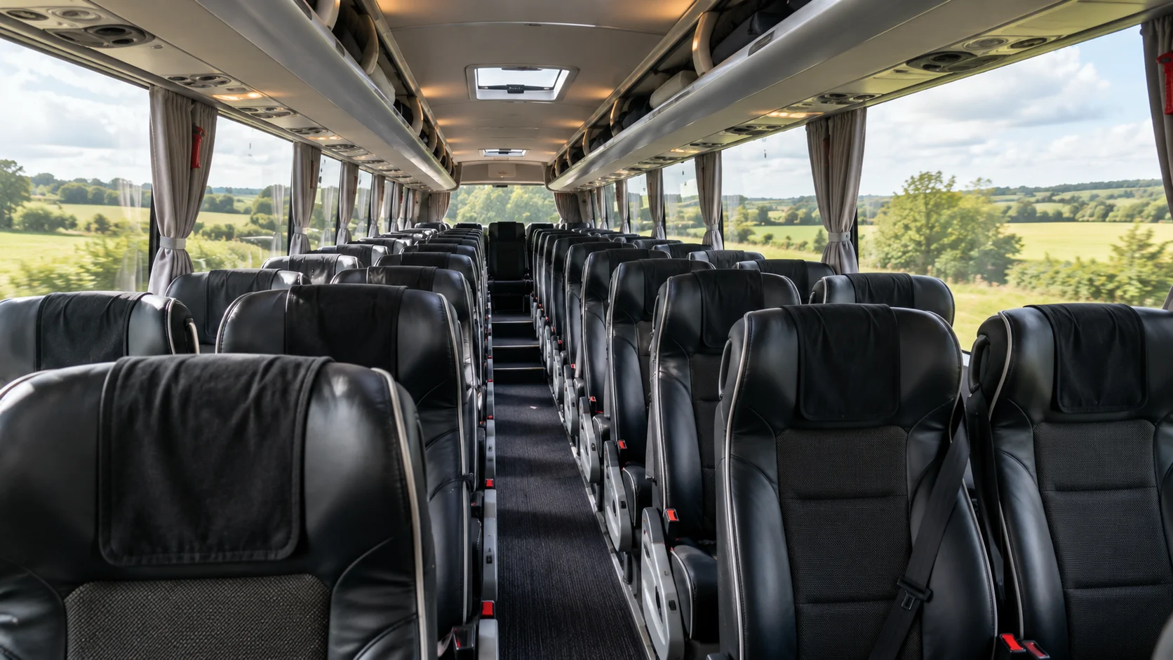 Coach interior with black quilted leather seats and warm aisle lighting